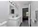 Bathroom featuring double vanity, large mirror and a view into a bedroom at 17468 Sw 36Th Ter, Ocala, FL 34473