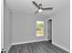 Bright bedroom features stylish gray floors, neutral walls and a ceiling fan at 17468 Sw 36Th Ter, Ocala, FL 34473