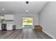 Dining area with pendant lighting, slider doors to the patio, and wood-look flooring at 17468 Sw 36Th Ter, Ocala, FL 34473