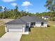 Beautiful single-story home featuring a two-car garage, well-maintained lawn, and classic white and gray color scheme at 17468 Sw 36Th Ter, Ocala, FL 34473