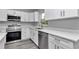 Close-up of the kitchen featuring stainless steel appliances, white cabinets, and quartz countertops at 17468 Sw 36Th Ter, Ocala, FL 34473