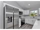 Bright, modern kitchen features stainless steel appliances, white cabinetry, and a functional layout at 17468 Sw 36Th Ter, Ocala, FL 34473