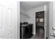 Laundry room with a newer black washer and dryer and access to the kitchen at 17468 Sw 36Th Ter, Ocala, FL 34473
