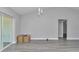 Open-concept living room with luxury vinyl plank flooring and a slider to the backyard at 17468 Sw 36Th Ter, Ocala, FL 34473