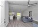 Open concept living room featuring vaulted ceilings, wood-look floors, and modern ceiling fan at 17468 Sw 36Th Ter, Ocala, FL 34473