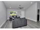 Well-lit living room featuring neutral walls, wood-look flooring, and comfortable seating at 17468 Sw 36Th Ter, Ocala, FL 34473