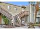 Charming two-story condo featuring a wooden staircase and a lush palm tree at 186 Scottsdale Sq # 186, Winter Park, FL 32792