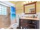 Bathroom featuring a tiled shower, toilet, and dark wooden sink vanity for a modern space at 2102 E Atmore Cir, Deltona, FL 32725
