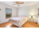 Cozy bedroom with laminate flooring, a ceiling fan, and a bright window at 2102 E Atmore Cir, Deltona, FL 32725