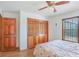 Bedroom features laminate floors, light walls, a ceiling fan, and a large closet at 2102 E Atmore Cir, Deltona, FL 32725