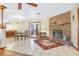 Open-concept living area featuring a brick fireplace and tile flooring at 2102 E Atmore Cir, Deltona, FL 32725