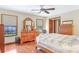 Relaxing main bedroom with hardwood floors, two windows, and wooden furniture at 2102 E Atmore Cir, Deltona, FL 32725