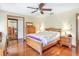 Comfortable main bedroom with a ceiling fan, hardwood floors, and ample closet space at 2102 E Atmore Cir, Deltona, FL 32725