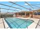 Inviting pool with screened-in enclosure, alongside the house, ideal for relaxation at 2102 E Atmore Cir, Deltona, FL 32725