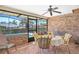 Enclosed sunroom with seating, exposed brick and views of the refreshing outdoor pool at 2102 E Atmore Cir, Deltona, FL 32725