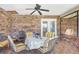 Enclosed sunroom offers outdoor access with its brick accent wall and seating at 2102 E Atmore Cir, Deltona, FL 32725