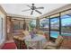Enclosed sunroom with brick walls, a ceiling fan, and outdoor pool view at 2102 E Atmore Cir, Deltona, FL 32725