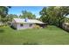 The home features a spacious backyard with a screened porch and lush landscaping at 222 Paul Mcclure Ct, Casselberry, FL 32707