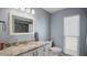 This well lit bathroom features a single sink vanity, granite countertops, and a mirror at 222 Paul Mcclure Ct, Casselberry, FL 32707