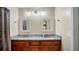 This bathroom features a double sink vanity with marble countertops and framed mirrors at 222 Paul Mcclure Ct, Casselberry, FL 32707
