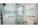 The renovated bathroom features a glass enclosed shower with decorative tile and a built in bench at 222 Paul Mcclure Ct, Casselberry, FL 32707