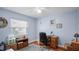 Bedroom area featuring wood floor, ceiling fan, window and a desk work space at 222 Paul Mcclure Ct, Casselberry, FL 32707