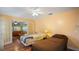 The bedroom has two beds, hardwood floors, a ceiling fan and french doors leading to another room at 222 Paul Mcclure Ct, Casselberry, FL 32707
