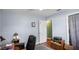 Office area featuring wood floor, ceiling fan and window, and a door at 222 Paul Mcclure Ct, Casselberry, FL 32707