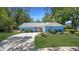 Charming single-story home featuring a blue brick exterior, well-maintained landscaping, and a paved driveway leading to the garage at 222 Paul Mcclure Ct, Casselberry, FL 32707