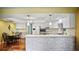 Bright kitchen featuring white cabinets, quartz countertops, a breakfast bar, stainless steel appliances, and hardwood floors at 222 Paul Mcclure Ct, Casselberry, FL 32707