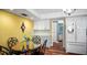 Kitchen features a round dining table, quartz countertops, white appliances, white cabinets, and hardwood floors at 222 Paul Mcclure Ct, Casselberry, FL 32707