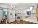 Bright kitchen showcasing quartz countertops, stainless steel appliances, a breakfast bar, white cabinets, and hardwood floors at 222 Paul Mcclure Ct, Casselberry, FL 32707