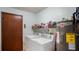 Functional laundry area with washer, dryer, water heater, shelving and a storage closet at 222 Paul Mcclure Ct, Casselberry, FL 32707