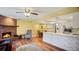 Spacious living room featuring a brick fireplace, hardwood floors, and an open layout leading to the kitchen and dining area at 222 Paul Mcclure Ct, Casselberry, FL 32707
