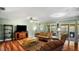A sunlit living room with sliding glass doors that lead to the backyard at 222 Paul Mcclure Ct, Casselberry, FL 32707