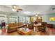 Open concept living room with hardwood floors, large windows, and a fireplace at 222 Paul Mcclure Ct, Casselberry, FL 32707