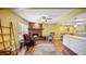 Spacious living room featuring a brick fireplace, hardwood floors, and an open layout leading to the kitchen and dining area at 222 Paul Mcclure Ct, Casselberry, FL 32707