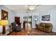 Comfortable living room with hardwood floors, neutral paint, and doorway to dining area at 222 Paul Mcclure Ct, Casselberry, FL 32707