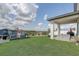 A spacious backyard offers ample green space and a covered patio, great for outdoor entertaining at 2412 Gold Dust Dr, Clermont, FL 34715