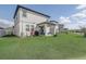 The backyard of this home features a covered patio and lush lawn, perfect for leisure activities at 2412 Gold Dust Dr, Clermont, FL 34715