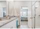 Bright bathroom featuring double granite vanity, framed mirror, and neutral tile flooring at 2412 Gold Dust Dr, Clermont, FL 34715