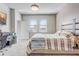 Bright bedroom with carpet flooring featuring a bed, desk, and windows for natural light at 2412 Gold Dust Dr, Clermont, FL 34715