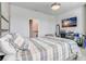 Modern bedroom with carpet floors, a TV, a desk, and an ensuite bathroom for added privacy at 2412 Gold Dust Dr, Clermont, FL 34715