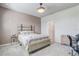 Comfortable bedroom with neutral decor featuring a wood-accent headboard and an ensuite bathroom at 2412 Gold Dust Dr, Clermont, FL 34715
