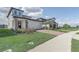Spacious two-story home featuring a well-manicured lawn and brick paved driveway at 2412 Gold Dust Dr, Clermont, FL 34715