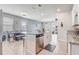 Stylish kitchen overlooking dining and living areas, featuring granite counters and a stainless steel dishwasher at 2412 Gold Dust Dr, Clermont, FL 34715