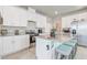 Well-equipped kitchen showcasing granite counters, stainless steel appliances, and a functional island with bar stools at 2412 Gold Dust Dr, Clermont, FL 34715