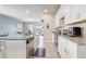 Modern kitchen offering granite counters, white cabinetry, and stainless appliances, open to a dining area at 2412 Gold Dust Dr, Clermont, FL 34715