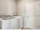 Bright laundry room featuring a washer and dryer set next to a door to the garage at 2412 Gold Dust Dr, Clermont, FL 34715