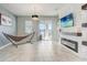 Stylish living room with a modern fireplace, large TV, and tile flooring at 2412 Gold Dust Dr, Clermont, FL 34715